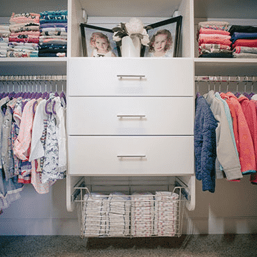 Children's clothing on racks, shelves and in drawers