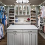 Boutique closet with clothing on shelves, in racks, and in drawers and cabinets