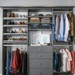 Reach in closet showing drawers, shelves and racks full of clothing