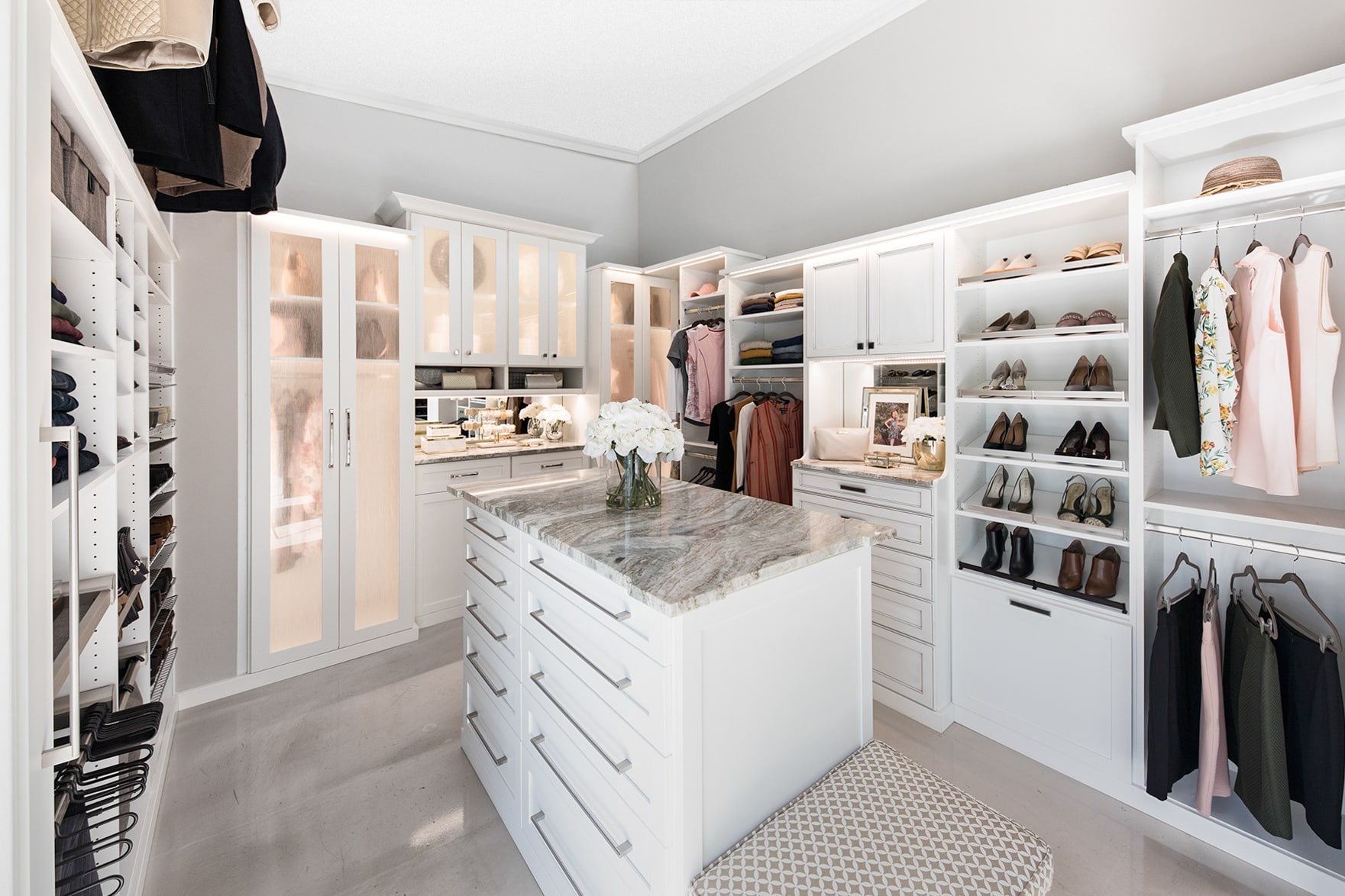 Floormountwalk inwhiteboutiqueclosetswithislands,custombuiltinandshoestorageinNaples,FL