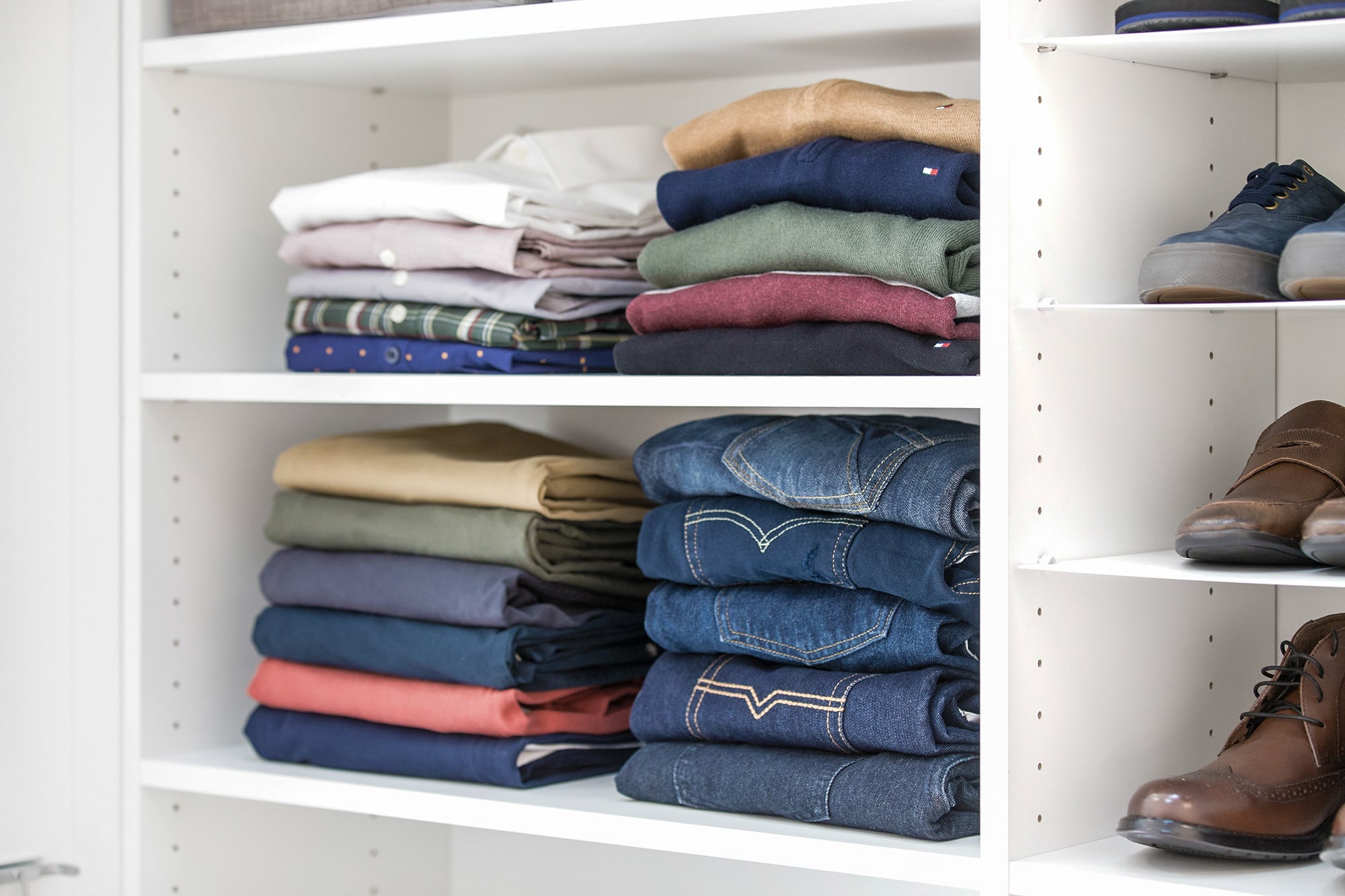 close up of clothing and shoes placed on shelves