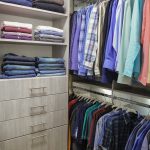 Close up of Inspired Closets closet with shelves, drawers and a clothing rack