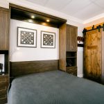 Custom murphy bed pulled out with storage drawers and cabinets in Sacramento