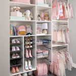 White little girls reach in closet with shoe and hanging storage in Las Vegas, NV